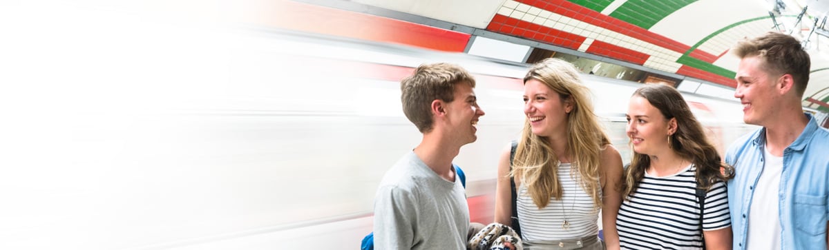 Parta kamarádů čekající na vlak.